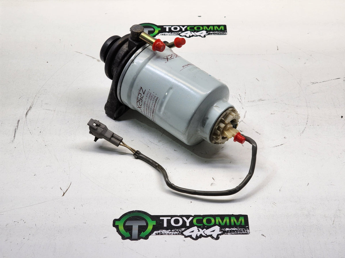 May 1990 to Mar 1998 - Toyota Land Cruiser 80 Series Diesel Turbocharged 4.2L Engine Code 1HD - Fuel Filter Housing - Hand Primer Pump
